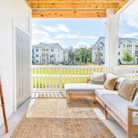 a patio with a couch and a ladder
