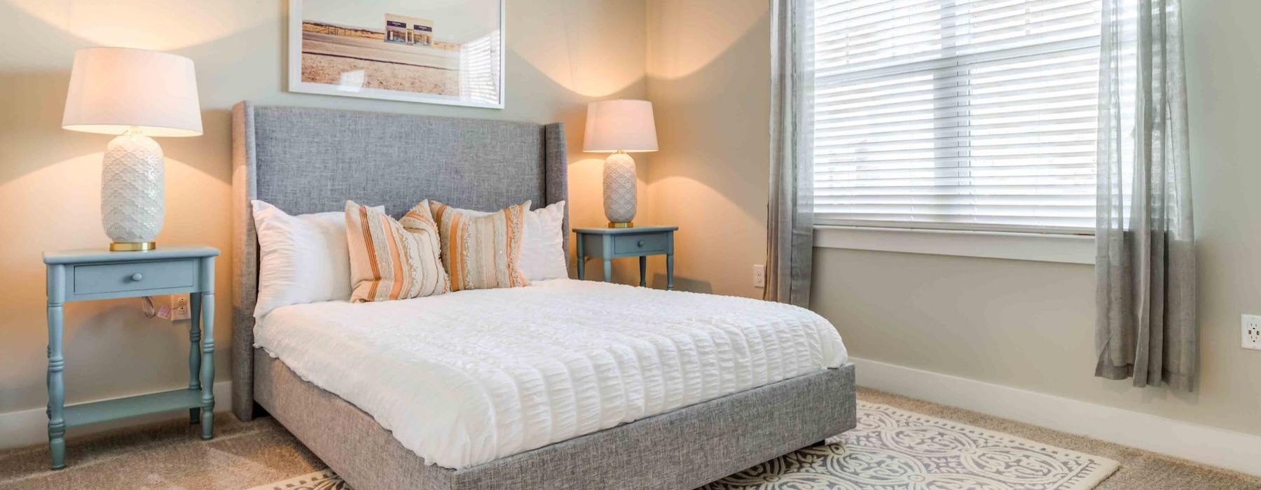 a bedroom with a bed and lamps