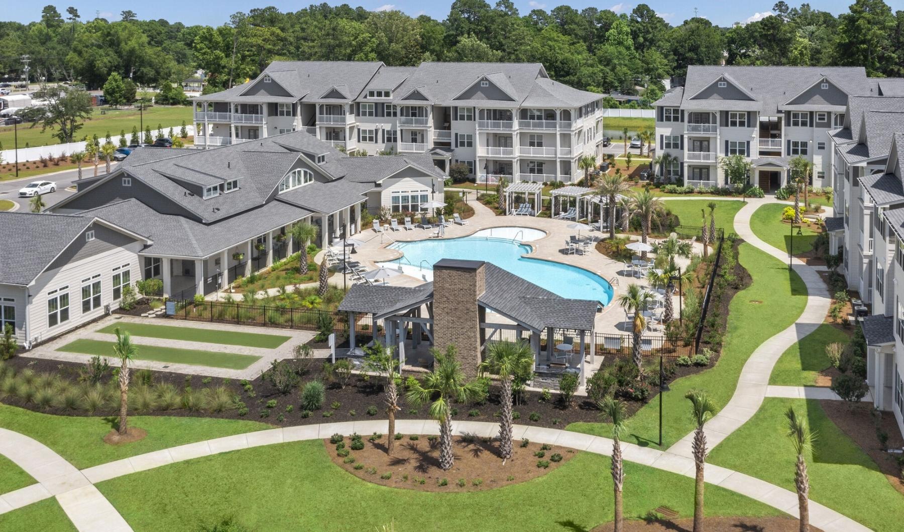 an aerial view of an apartment complex with a pool
